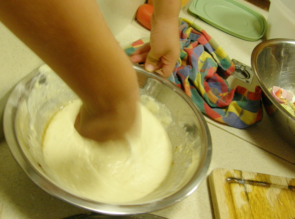 Child's hands mixing pancake batter