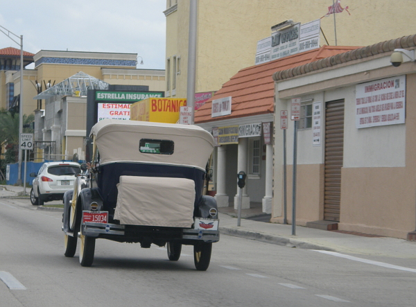 Antique car driving down Flagler Street in Miami
