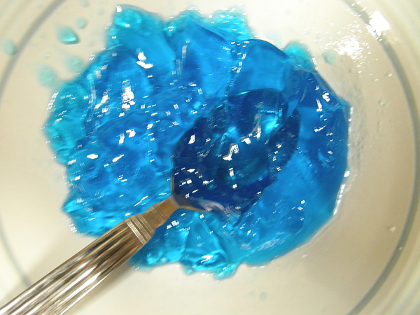 Blurry photo of bowl of half-eaten blue Jello.