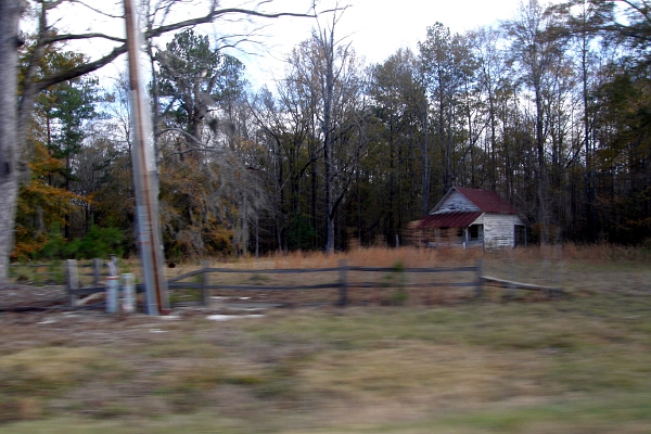 Blurry Alabama countryside with small house at 55 mph