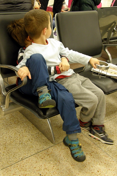 Two boys in a chair at the airport
