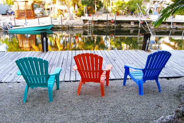 Three chairs at a dock.