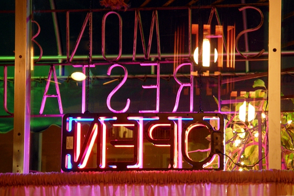 Neon signs viewed from inside the restaurant