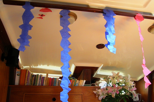 Home made tissue paper streamers hanging from ceiling of the boat.