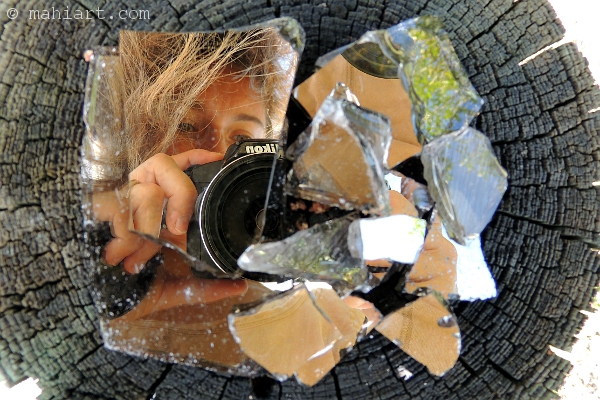 Self portrait as reflected in the pieces of a broken mirror