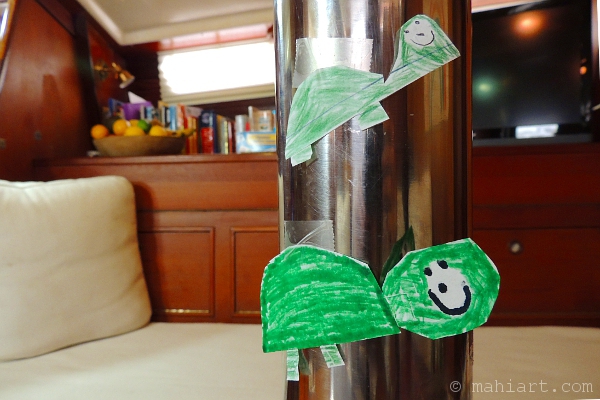 Kids turtle crafts stuck on the mast inside a sailboat