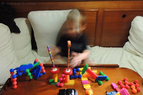 Child's block constructions with pencils stuck in them