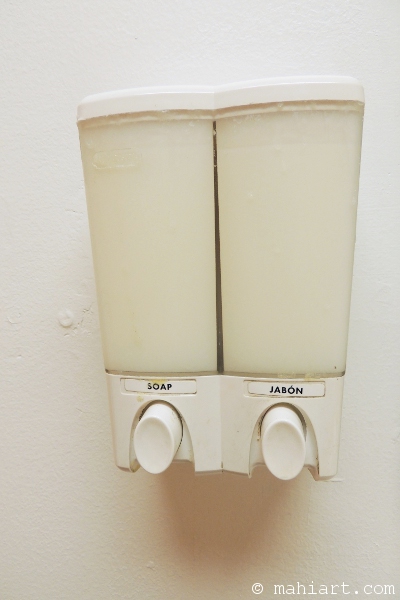 Soap dispenser labeled in English and Spanish
