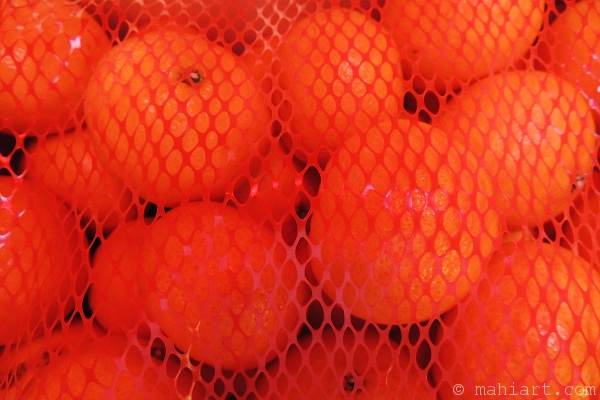 Tangerines seen through netting