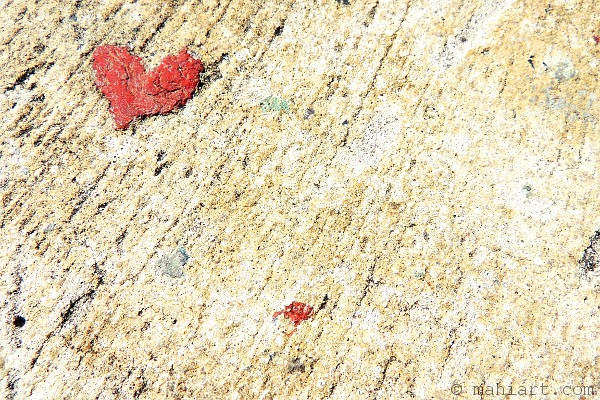 Paint drip heart on concrete pavement