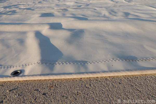 Sail spread out on pavement