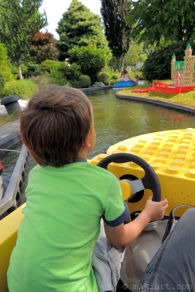 Boy driving boat at legoland