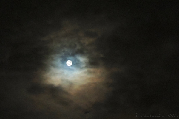 Moon shining through clouds