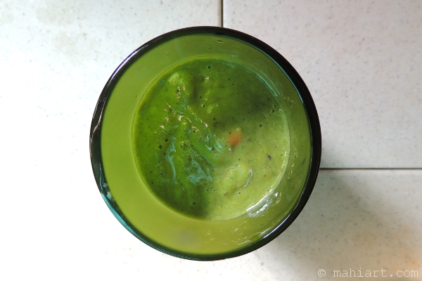 Green smoothie in recycled wine bottle glass