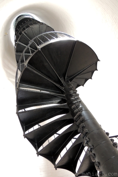 Black spiral staircase inside the white tower of the Key Biscayne lighthouse