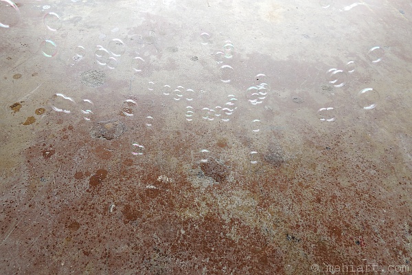 Bubbles floating over concrete floor