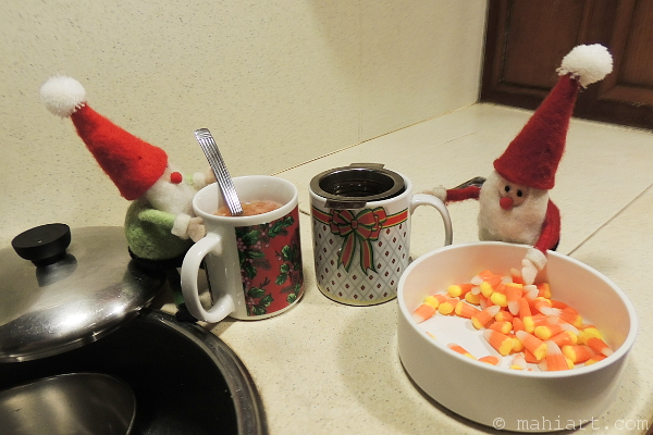 Elves on kitchen counter, making candy corn tea