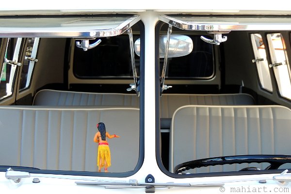 Dashboard hula girl in the front window of a vintage Volkswagen Kombi van